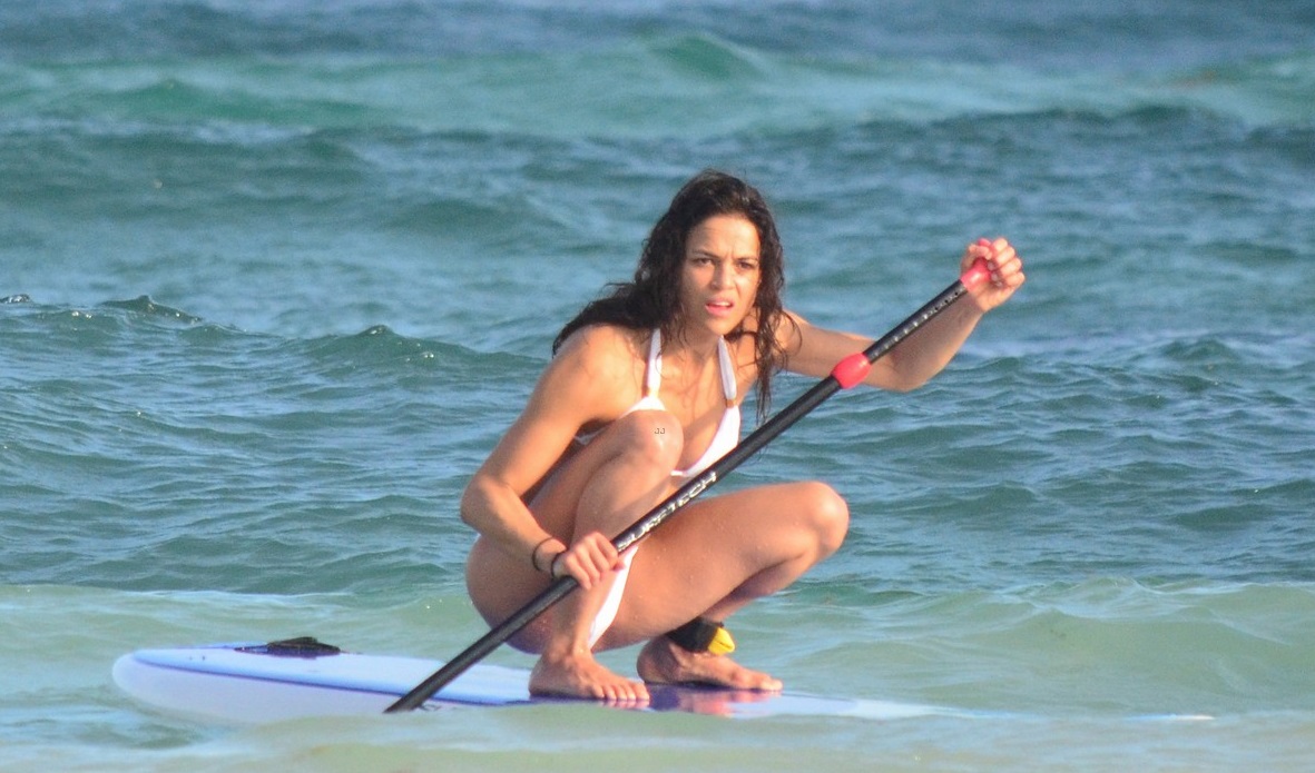 **USA ONLY** *EXCLUSIVE* **SHOT ON 12/31/14** Tulum, Mexico - Michelle Rodriguez shows off her enviable figure while enjoying a beach day alone in Mexico, wearing a white bikini. The actress stayed cool in the water and went paddle boarding. Michelle has definitely been making the most of her break from Hollywood and recently shared, "This year has been too much and I need some time out" and added, "I've been working hard and now I want time off. That's what I do. Work hard, play hard. I don't think that's much to ask or want". AKM-GSI December 31, 2014 **USA ONLY** To License These Photos, Please Contact : Steve Ginsburg (310) 505-8447 (323) 423-9397 steve@akmgsi.com sales@akmgsi.com or Maria Buda (917) 242-1505 mbuda@akmgsi.com ginsburgspalyinc@gmail.com